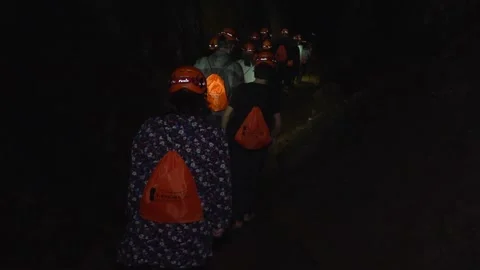 Hikers Walking Through Abandoned Mine Tunnels Lit by Headlamps - 15 Stock Footage 308401481