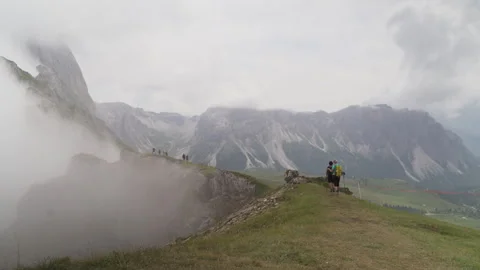 Hikers walking toward low clouds over mountain Stock Footage 289088126