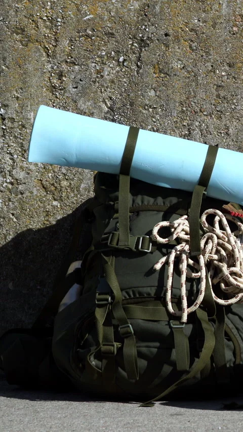 Hiking backpack with camping equipment outdoors. Vertical video Stock Footage 336408089