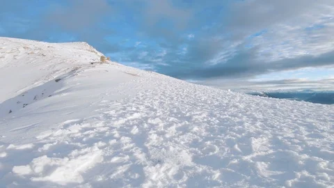 Hiking with backpack on a steep snow covered mountain in the alps Stock Footage 100053453