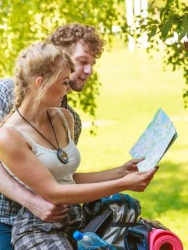 Hiking backpacking couple reading map on trip. Stock Photos