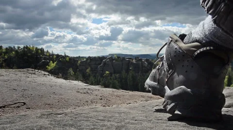 Hiking boot on stone with forest background Stock Footage 40003641