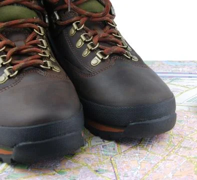 Hiking boots and map Stock Photos