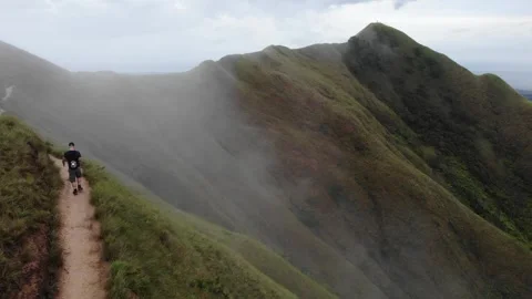 HIKING on CLOUDY mountain RIDGE (drone shot) Stock Footage 252050508