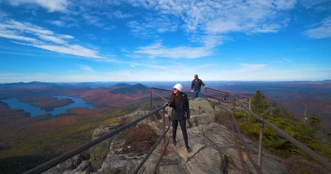 Hiking Couple Exploring Peak of Mountain, Lake Placid NY Stock Footage 102401470
