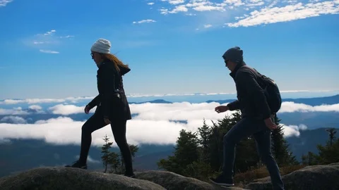 Hiking Couple Overlooks Lake From Peak of Mountain Video stock 102401341