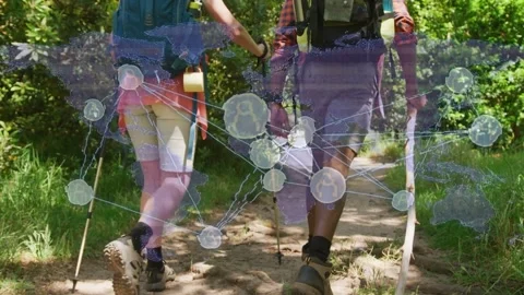 Hiking couple walking path with poles, brief touch, camera rising, tech overlay Stock Footage 333192995