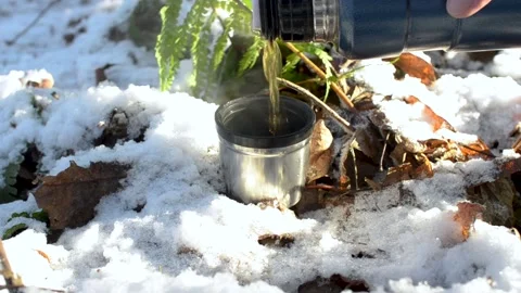 Hiking cup standing in winter forest, close-up. Man pouring hot tea Stock Footage 145270649