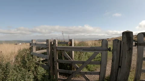 Hiking going through gate on way to Pym Chair Peak District Stock Footage 160680002