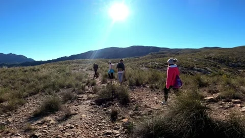 Hiking group walking through path in mountain top against beautiful landscape Video stock 146363795