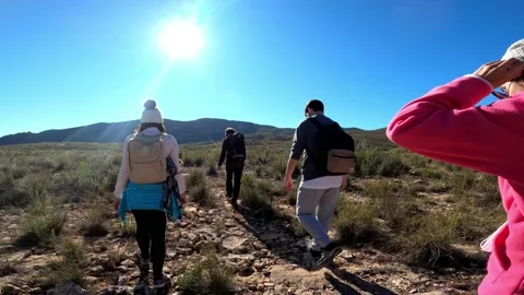 Hiking group walking through path in mountain top against beautiful landscape Stock-Footage 146363825