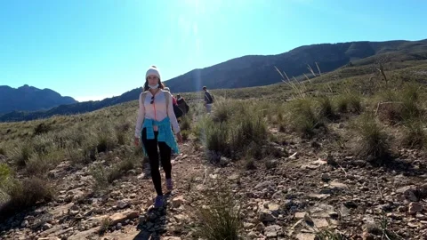 Hiking group walking through path in mountain top against beautiful landscape Video stock 146363889