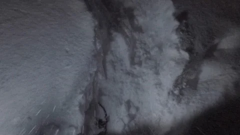 Hiking with a lantern on snow path exploring at night in slow motion Stock Footage 104188656