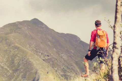 Hiking man with backpack in mountains Stock Photos