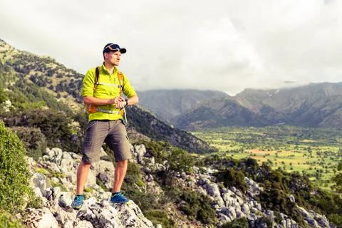Hiking man checking direction in mountains Stock Photos