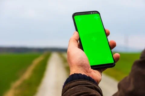 Hiking man with leather jacket using his smart phone to navigate  Stock Photos