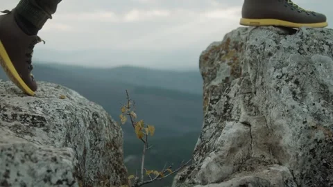 Hiking man in mountains. Close-up of man's legs walking on mountain Stock Footage 317214959