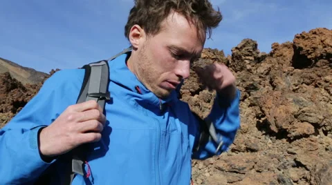 Hiking man putting on backpack walking on hike - Hiker backpacking Stock Footage 45572912