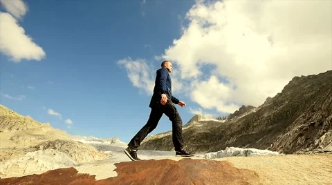 Hiking man walking on top of mountain cliff in majestic scenery Stock Footage 42942298