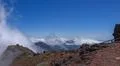 Hiking on mountain ridge w heavenly clouds on mountain peak in La Palma island Photo