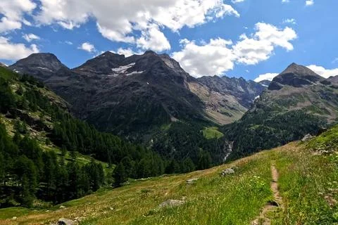 Hiking Path on Grassy Mountain Slope in Italy Stock Photos