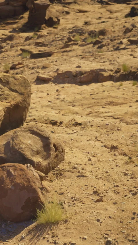 Hiking path through rocky terrain in a desert landscape during daytime Video stock 331760158