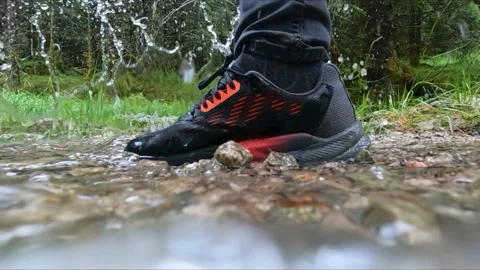 Hiking in the rain in Norway, splashing water from a small stream, puddle Stock Footage 221181663