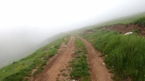 Hiking on a road in the mountains Stock Footage 133285654