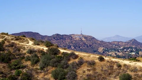 Hiking Runyon Canyon with a View of The Hollywood Sign by Aerial Drone Vídeos de archivo