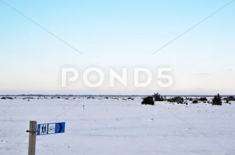 Hiking sign at a snowy landscape Stock Photos