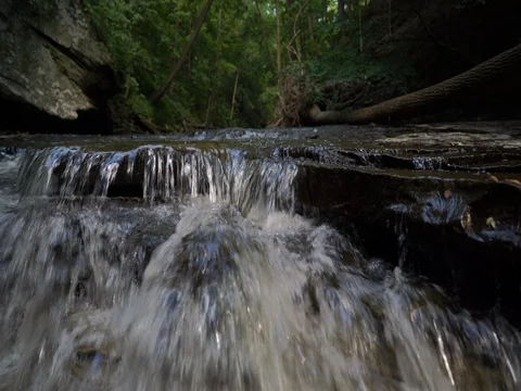 Hiking up stream over small waterfalls in Cuyahoga Valley Video stock 77163052