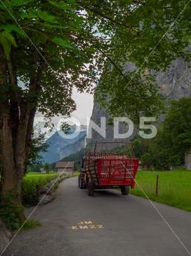 Hiking street at Lauterbrunnen mountains in Switzerland with tree and tractor Stock Photos