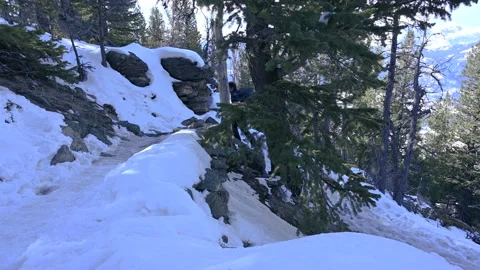 Hiking a switchback on snowy trail Stock Footage 151058499
