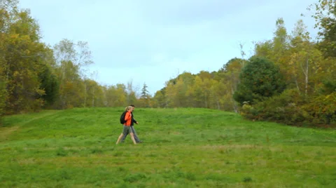 Hiking through a big open field in early autumn, medium shot. Stock Footage 31822951