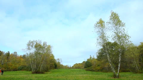 Hiking through a big open field in early autumn, wide shot. Stock Footage 31822989