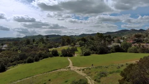 Hiking through a grassy hillside Stock Footage 241551735