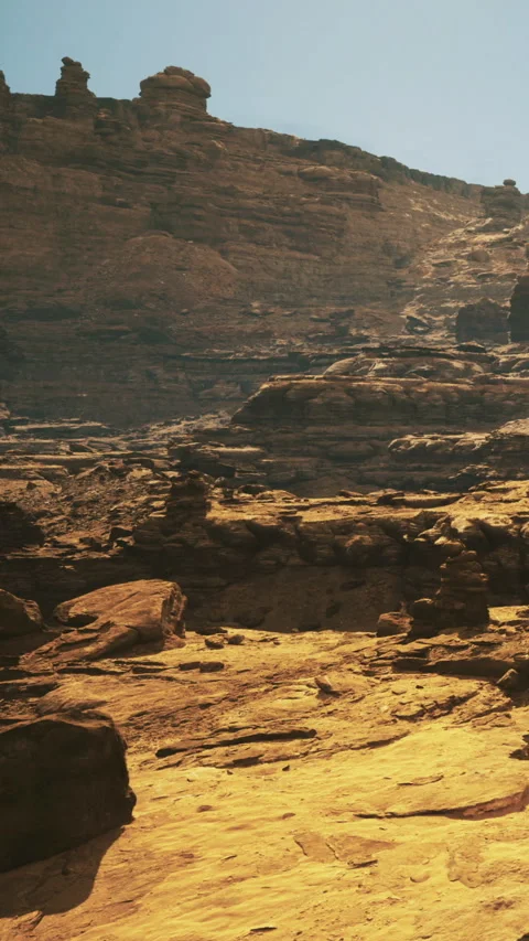 Hiking through rocky terrain in a desert landscape during bright daylight Video stock 332211751