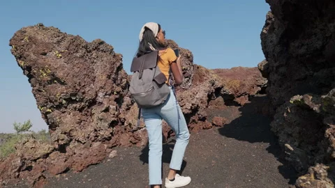 Hiking through unique mound rocks landscape on a clear day Stock Footage 312653124