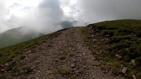 Hiking trail with clouds over the mountain Stock Footage