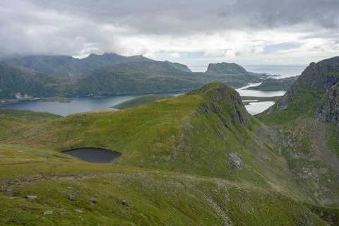 Hiking trail path through lakes valley cloudy view from Ryten mountain Stock Photos
