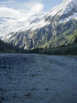 Hiking trail with view to mountain range snowcapped Stock Photos