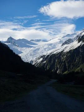 Hiking trail with view to mountain range snowcapped Stock Photos