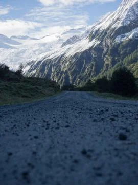Hiking trail with view to mountain range snowcapped Stock Photos
