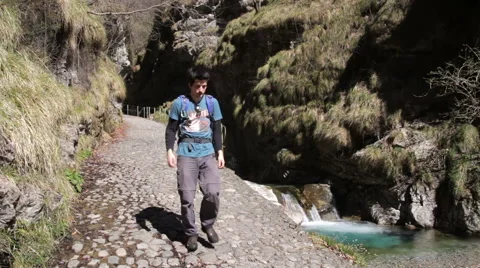 Hiking - Walk into a gorge on cobbled path Romano Stock Footage 49011101