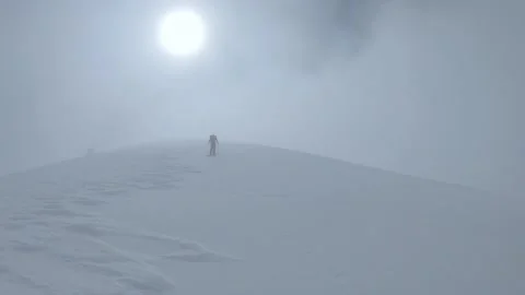 Hiking within fog on a splitboard in cloudy mountain landscape Stock Footage 237166078