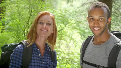 Hiking young couple smile into the camera in the woods Stock Footage 44790613