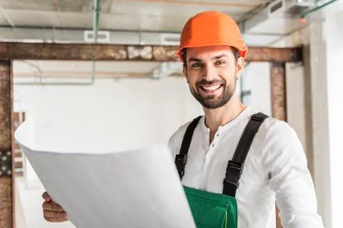 Hilarious smiling builder keeping document Stock Photos
