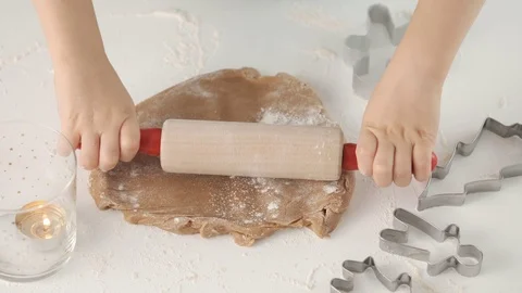 Hild rolls the dough for gingerbread. Son and mother make christmas gingerbread Stock Footage 121120156