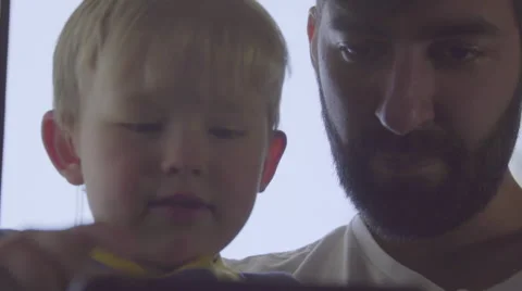 Hild teaches dad about mobile phone Stock Footage 64403845