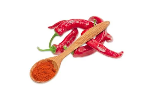 ?hili powder in a wooden spoon and several fresh chili Stock Photos